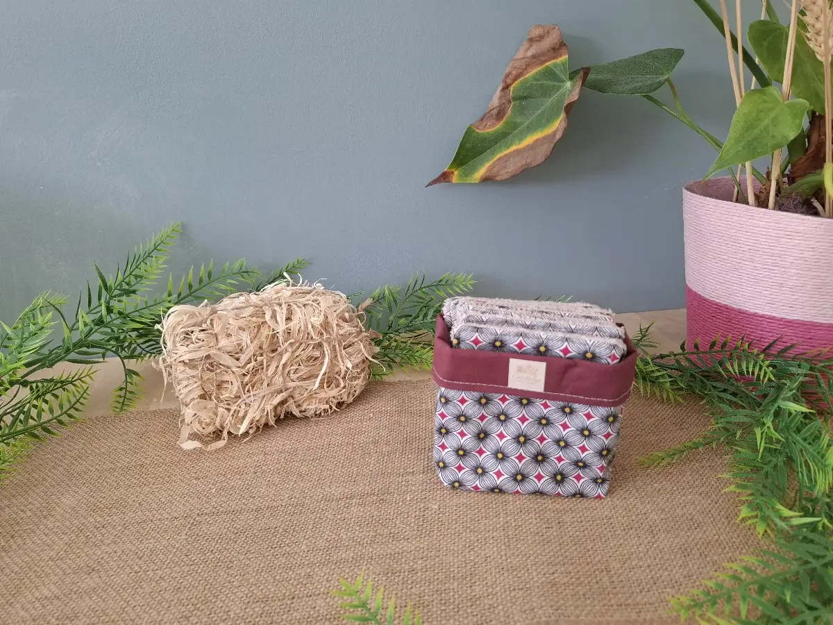Panier et ses lingettes démaquillantes sur fond bordeaux